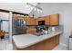 Functional kitchen with stainless steel appliances, light wood cabinets, and ample counter space at 16011 Saddle Creek Dr, Tampa, FL 33618