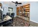 A home office with a ceiling fan and extensive built-in shelving for storage at 16011 Saddle Creek Dr, Tampa, FL 33618