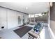 This patio includes chairs, an outdoor rug, and a door to the interior of the home at 16011 Saddle Creek Dr, Tampa, FL 33618