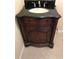 Bathroom with ornate vanity, a black granite countertop, and a decorative vessel sink at 17220 Estes Rd, Lutz, FL 33548