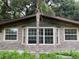 Close-up of the brick facade, bay window, and windows of this house at 17220 Estes Rd, Lutz, FL 33548
