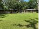 Sprawling front yard with mature trees and a single-story home in the background at 17220 Estes Rd, Lutz, FL 33548