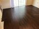 Living room features newly installed dark hardwood flooring and ample natural light at 17220 Estes Rd, Lutz, FL 33548
