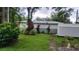 A spacious backyard with lush greenery, mature trees, plants, and a small storage shed at 1735 Cleveland St, Clearwater, FL 33755