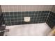 Close-up of a clean bathtub with tile surround and chrome fixtures at 1735 Cleveland St, Clearwater, FL 33755