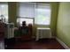 Bedroom with hardwood floors, window with blinds, and furniture at 1735 Cleveland St, Clearwater, FL 33755