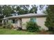 Quaint home with a well-maintained yard and garden, showcasing its curb appeal at 1735 Cleveland St, Clearwater, FL 33755