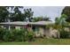Inviting single-story home surrounded by lush landscaping and vibrant flowering plants at 1735 Cleveland St, Clearwater, FL 33755