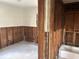 Interior bathroom with a bathtub and damaged walls, ready for complete remodeling at 2011 Oakwood Ave, Tampa, FL 33605