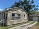 Exterior of home featuring neutral siding and a long driveway leading to a detached garage at 2011 Oakwood Ave, Tampa, FL 33605