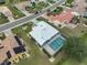 Aerial view of a beautiful single-Gathering home with a screened in pool and white stone landscaping at 2252 New Bedford Dr, Sun City Center, FL 33573