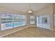 Dining area with ample natural light, wood floors, ceiling fan and sliding glass doors providing views of the pool at 2252 New Bedford Dr, Sun City Center, FL 33573