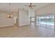 Open-concept living room featuring hardwood floors, high ceilings, and sliding glass doors to the pool at 2252 New Bedford Dr, Sun City Center, FL 33573