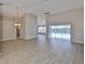 Spacious living room with wood floors, ceiling fan, and sliding doors to the outdoor pool at 2252 New Bedford Dr, Sun City Center, FL 33573