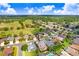 An aerial shot of a house in a suburban neighborhood with a golf course nearby at 23325 Abercorn Ln, Land O Lakes, FL 34639