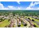 An aerial view of the home in a vibrant community surrounded by lush greenery and a golf course at 23325 Abercorn Ln, Land O Lakes, FL 34639