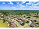 An aerial view of the property showcasing a pool, lush landscaping, and nearby golf course at 23325 Abercorn Ln, Land O Lakes, FL 34639