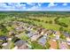 Aerial view of a residential community with lush landscaping, tree coverage and a golf course at 23325 Abercorn Ln, Land O Lakes, FL 34639