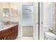Bathroom with granite countertops, dark wood cabinets, and toilet at 23325 Abercorn Ln, Land O Lakes, FL 34639