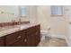 Bathroom with granite countertop, brown cabinetry, and tile floors at 23325 Abercorn Ln, Land O Lakes, FL 34639