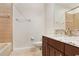 Bathroom with granite countertop, dark wood cabinets, and a bathtub at 23325 Abercorn Ln, Land O Lakes, FL 34639