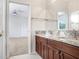 Bathroom featuring double sinks, granite countertops, and dark wood cabinets at 23325 Abercorn Ln, Land O Lakes, FL 34639