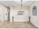 Elegant dining room with tray ceiling, modern chandelier, and neutral décor at 23325 Abercorn Ln, Land O Lakes, FL 34639