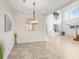 Dining area with tile floors, chandelier, and an open view into the foyer at 23325 Abercorn Ln, Land O Lakes, FL 34639