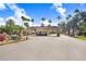 A beautiful gated entrance to the Plantation Palms Golf and Country Club community with tropical landscaping at 23325 Abercorn Ln, Land O Lakes, FL 34639