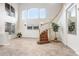 Bright foyer with high ceilings, decorative lighting, and a staircase with white railing at 23325 Abercorn Ln, Land O Lakes, FL 34639