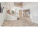 Open foyer with a staircase, tile flooring, and views into the living spaces at 23325 Abercorn Ln, Land O Lakes, FL 34639
