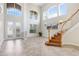 Grand foyer featuring soaring ceilings, large windows, tile flooring, and a staircase at 23325 Abercorn Ln, Land O Lakes, FL 34639