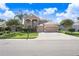 Gorgeous two-story home showcasing a spacious three-car garage, mature landscaping, and manicured lawn at 23325 Abercorn Ln, Land O Lakes, FL 34639