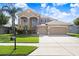 Charming two-story home with a three car garage, beautiful windows, and a well-manicured lawn at 23325 Abercorn Ln, Land O Lakes, FL 34639