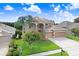 Elegant two-story home featuring a three car garage and a beautifully landscaped front yard at 23325 Abercorn Ln, Land O Lakes, FL 34639