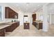 Gourmet kitchen with dark wood cabinets, stainless steel appliances, and granite countertops at 23325 Abercorn Ln, Land O Lakes, FL 34639