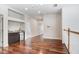 Upper-level landing with hardwood floors, a mini fridge, and views of the living space at 23325 Abercorn Ln, Land O Lakes, FL 34639