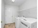 Functional laundry room features a washer, dryer, and built-in shelving for storage at 23325 Abercorn Ln, Land O Lakes, FL 34639