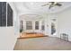 Open-concept living room with hardwood floors, multiple windows, and an outside patio at 23325 Abercorn Ln, Land O Lakes, FL 34639