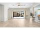 Bright living room with tile flooring and sliding glass doors leading to an outdoor waterfall feature at 23325 Abercorn Ln, Land O Lakes, FL 34639
