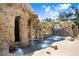 The impressive pool with rock waterfall and grotto offers a unique and luxurious outdoor experience at 23325 Abercorn Ln, Land O Lakes, FL 34639