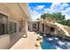 View of the pool, which features a rock waterfall structure and ample patio seating at 23325 Abercorn Ln, Land O Lakes, FL 34639