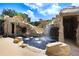 The pool features a grotto with multiple waterfalls and plenty of space to enjoy the water at 23325 Abercorn Ln, Land O Lakes, FL 34639