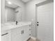Updated bathroom with vanity and mirror at 2433 Blind Pond Ave, Lutz, FL 33549