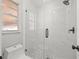 This bathroom includes a white marble-look shower and toilet at 2433 Blind Pond Ave, Lutz, FL 33549