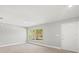Bright bedroom features a large window and modern flooring at 2433 Blind Pond Ave, Lutz, FL 33549