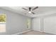 This bedroom has a ceiling fan and two large windows, as well as a closet at 2433 Blind Pond Ave, Lutz, FL 33549