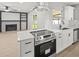 Bright kitchen featuring an island, stainless steel appliances, quartz countertops, and an open layout at 2433 Blind Pond Ave, Lutz, FL 33549