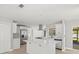 Bright kitchen with a central island, stainless steel appliances, white cabinets, and modern tile flooring at 2433 Blind Pond Ave, Lutz, FL 33549
