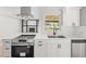 Close up of kitchen featuring stainless appliances, white cabinetry and modern countertops at 2433 Blind Pond Ave, Lutz, FL 33549